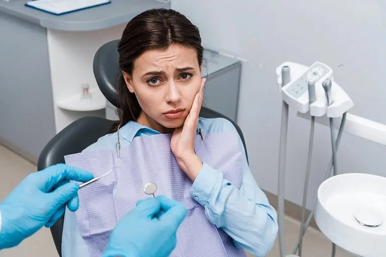 selective focus dentist latex gloves holding dental instruments upset woman - TMJ Treatment in Suwanee and Tucker, GA