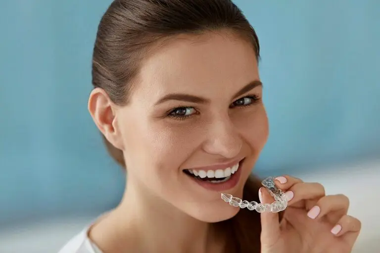 dental care smiling woman using invisalign clear aligners - How Does Invisalign Work in Suwanee and Tucker, GA